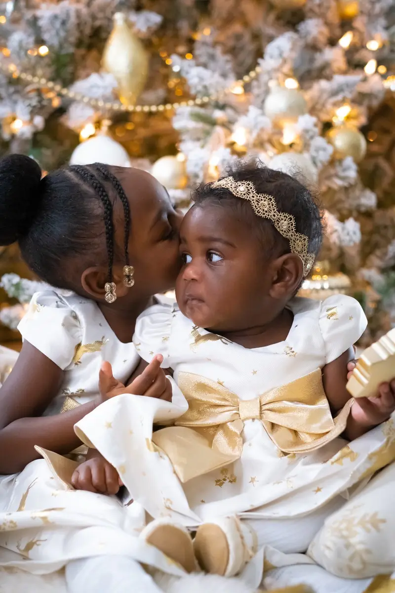 Two sisters at Christmas tree