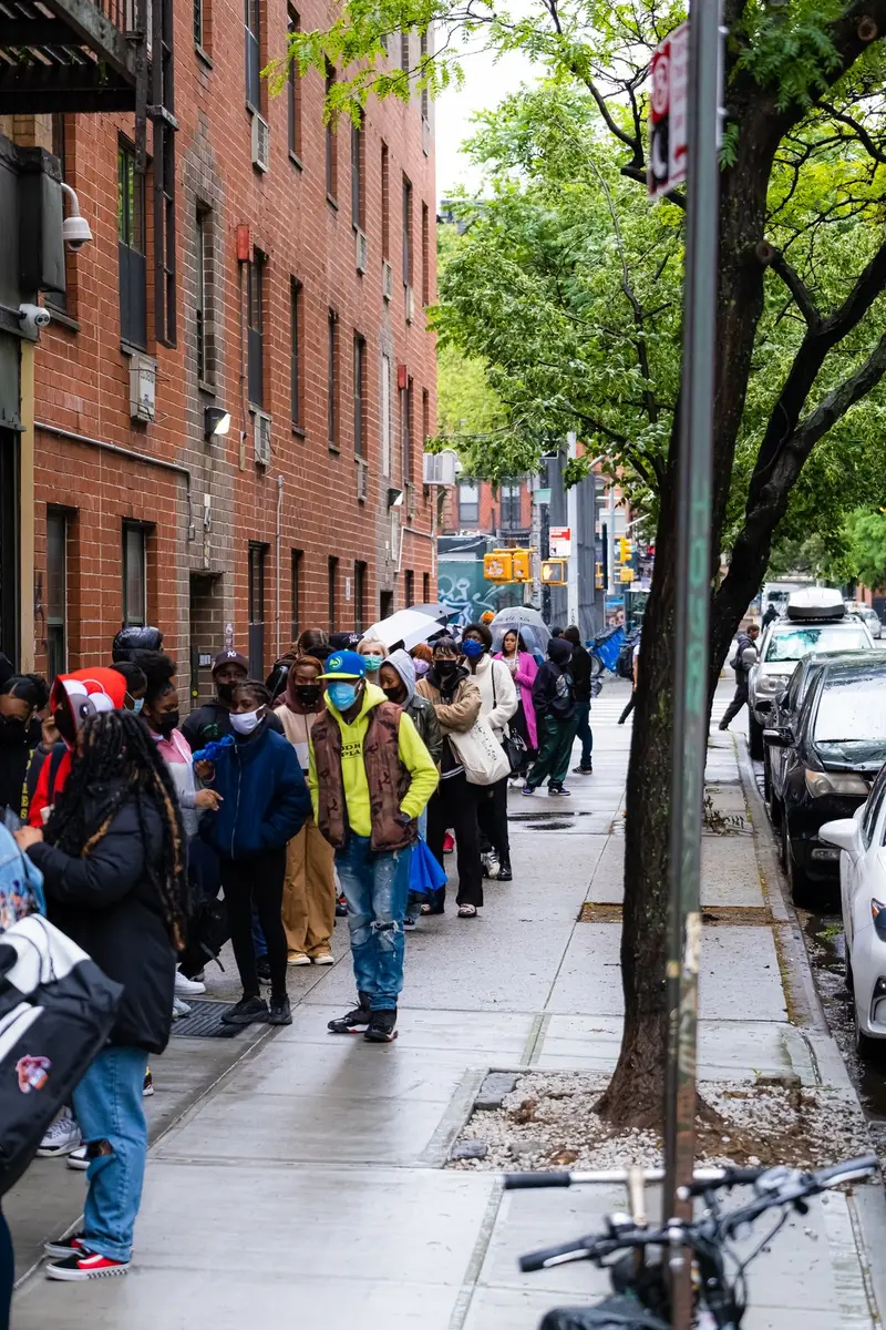 Masked queue on sidewalk