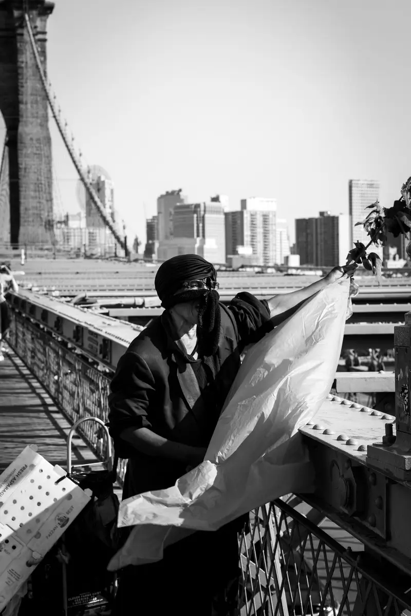 Man with bag on bridge walkway