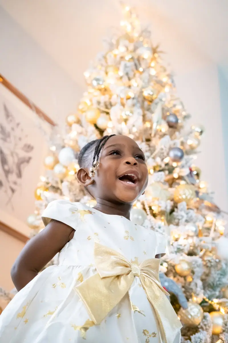 Girl laughing by tree