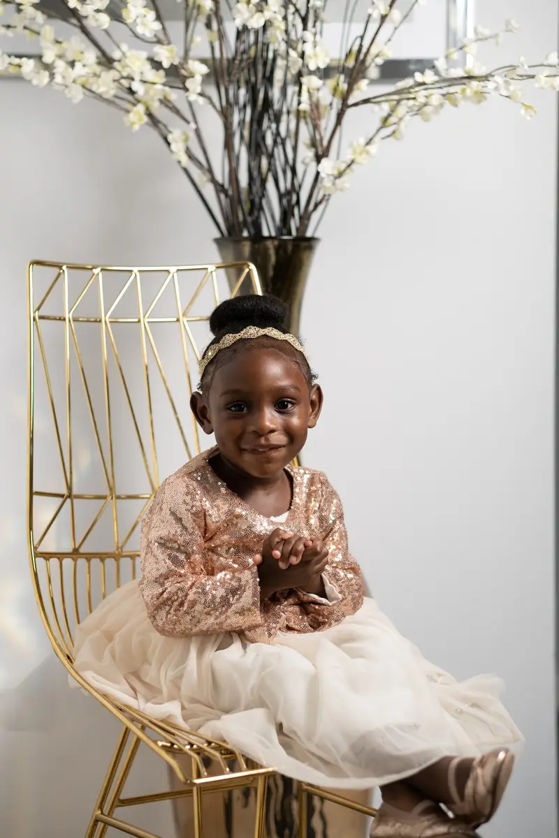 Girl in gold on chair