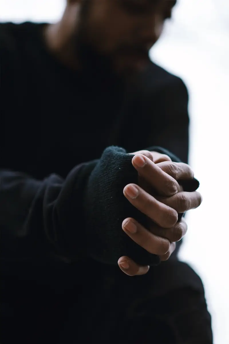 Praying hands, black hoodie