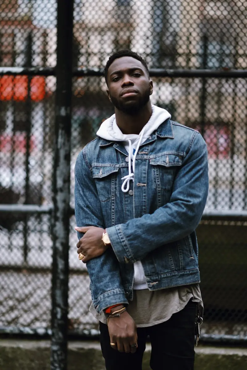 Jean jacket, hoodie, fence