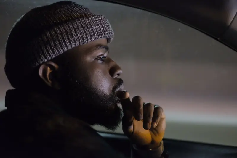 Man in beanie, car window