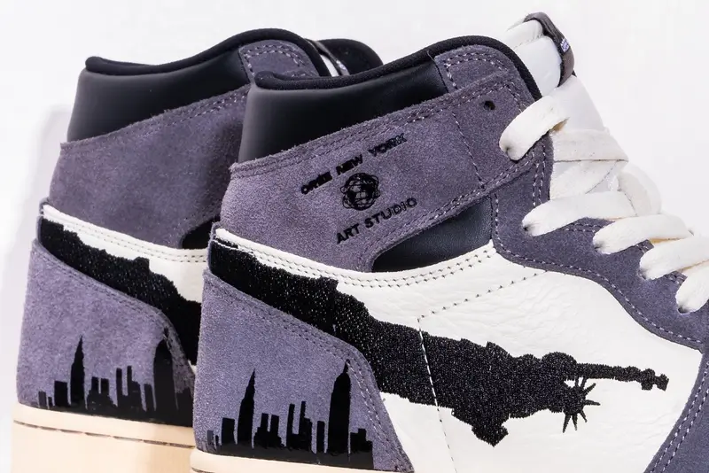A pair of sneakers set against a skyline panel