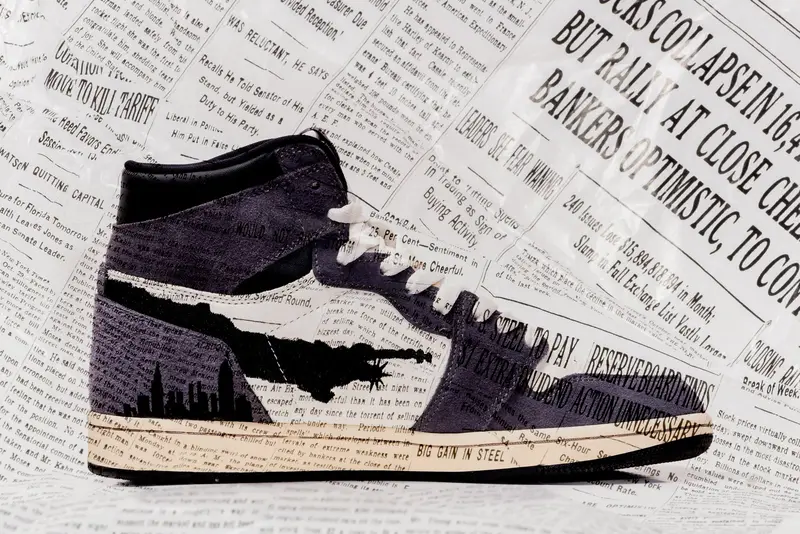 Custom newsprint-wrapped sneaker on a dark backdrop